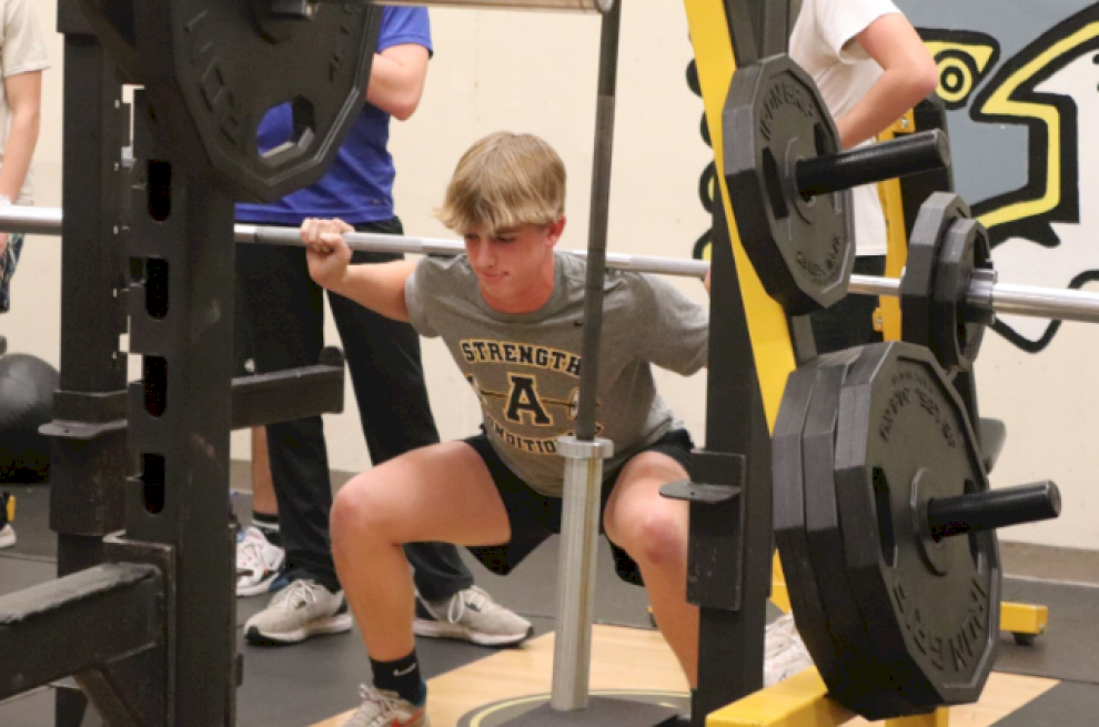 DEPTH FINDER - Freshman Grant Petty, does a few warm up reps with 115lbs on the bar. Petty made sure he was getting low enough to count it as a rep. After he racked the bar, it was time for him to test out his back squat.
