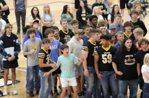 A crowd of students stand engrossed in the first day rock-paper-scissors tournament.