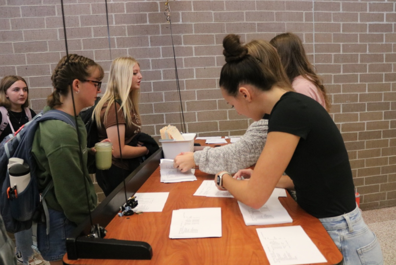 Members of the AHS Student Council distribute printed class schedules to incoming students.