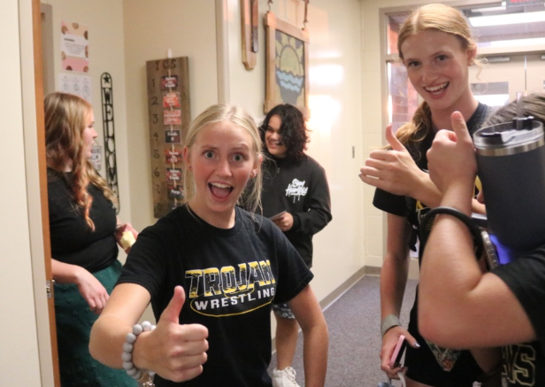 Students Lily Willrich (10), AK Hartman (9), and Brynn Lamp (10) don smiles at Back-To-School Night.