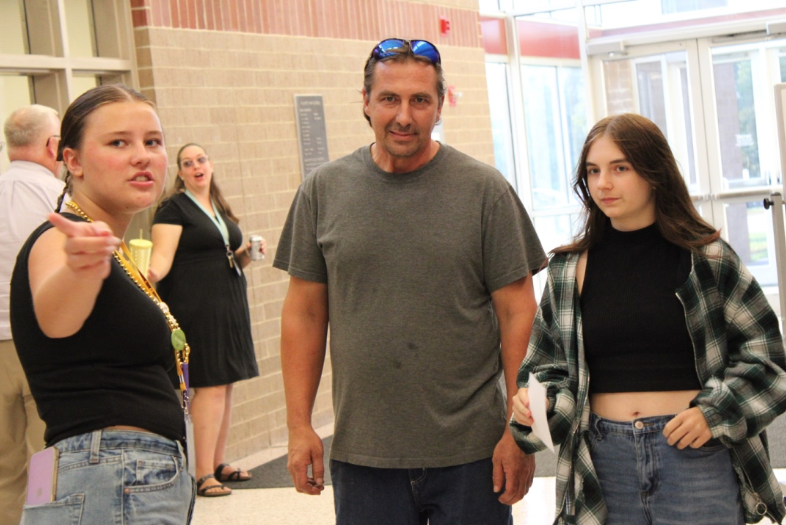 Senior journalist Isabelle Symonds points freshman Jersey Goldberg and her father in the right direction.