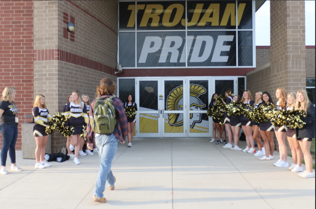 Sophomore Zephyr Mitchell walks into the AHS entryway lined by cheerleaders. Every Friday on the day of a home football game, the cheerleaders would greet those who walked into class.