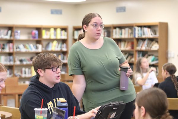 AHS Student Council advisor Mrs. McBee works with Sophomore Rayden Wheeler during a student council meeting.