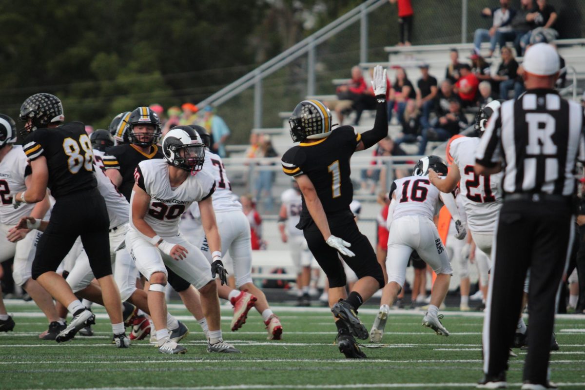 Number 1 on the Football team, Carter Hadley throws the ball to his teammates at the Football game. Hadley is a senior player at AHS