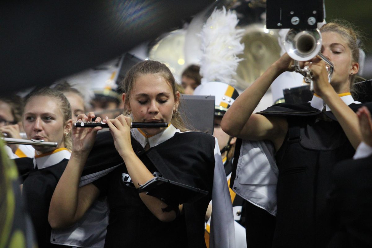 Olivia Jensen plays her piccolo after the AHS Football team scores a touchdown. The band plays before the game, after every touchdown, and during halftime.