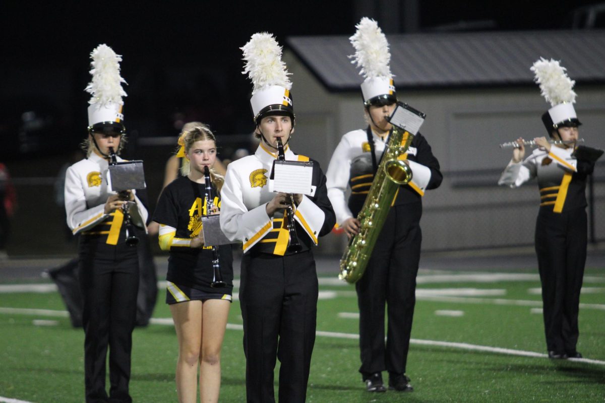 Members of the Trojan Guard Bella Brock, Jayna McEntaffer, Drace Moore, Fletchor Toft, and Blake Wood play their James Bond half-time show during the varsity football game vs. Green County on September 14, at the Trojan Bowl.