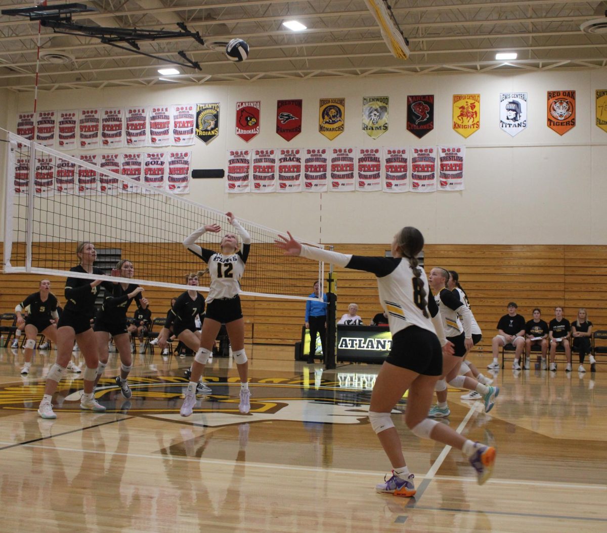 Sophomore Peyton McLaren sets the volleyball to junior Jayci Reed during the Varsity Volleyball game vs Glenwood!