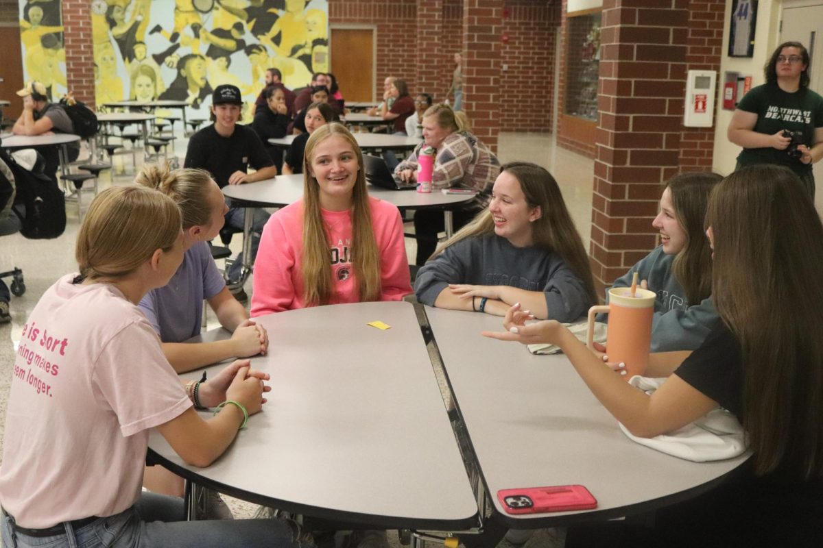 AHS juniors Ella Brummer, Jersey  Green, Olivia Olson, Kenzie Swanson, Keely Swanson, and Olivia Jensen discuss their ideas for the homecoming float during seminar.