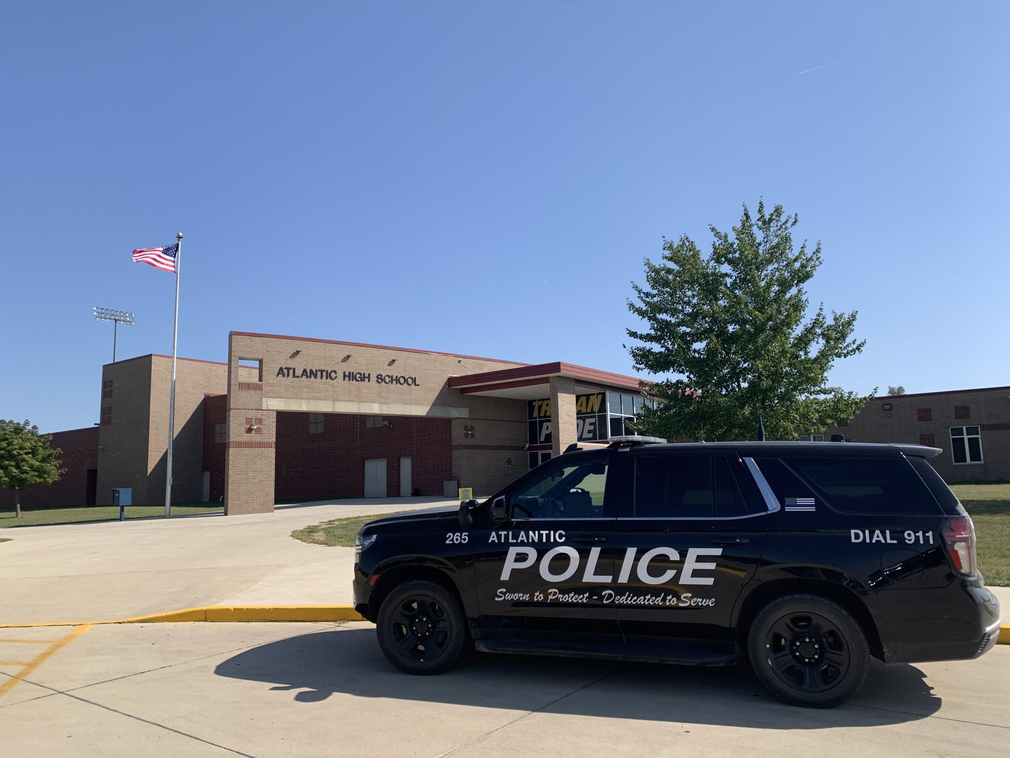 A police car stands posted outside the Atlantic High School on Monday, September 9, as a result of increased police security following the school shooting threat.