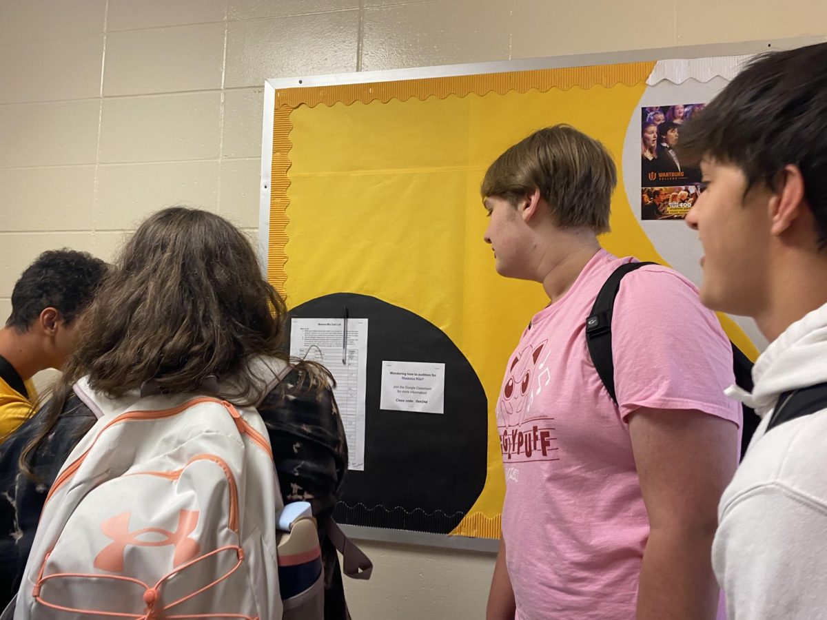 Ismael Elba, Grace Mitchell, Knox McCalla, and Nico McBride gather around the official cast list for the 2024 fall musical.