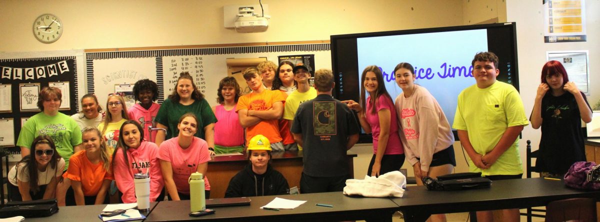 Ms. Misner's freshman class poses for a homecoming week photo dressed in NEON!