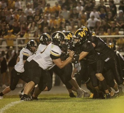 The Trojan offensive line defends their quarterback, Tristan Hayes, against the Winterset Huskies, Sept. 20, 2024. 