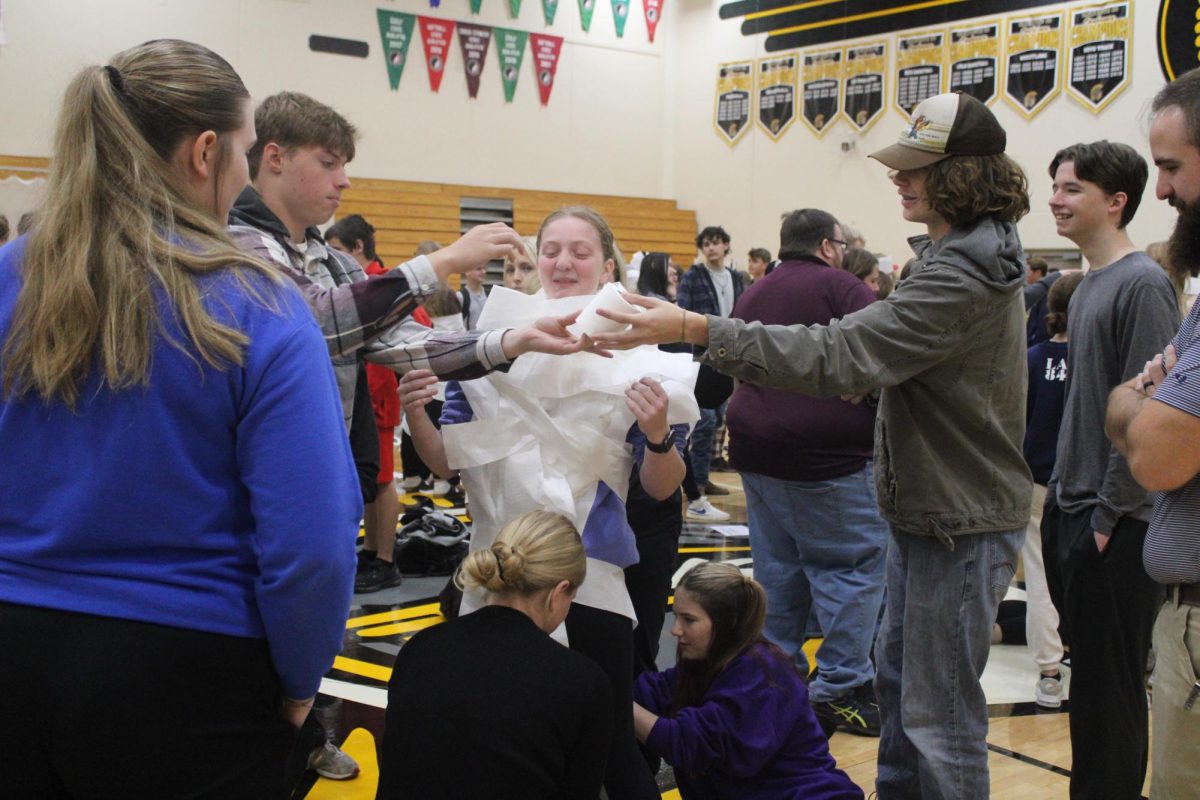 Nissa Molgaard a senior at AHS gets wrapped in toilet paper while her seminar class tries to win the mummy race on October 28, 2024.