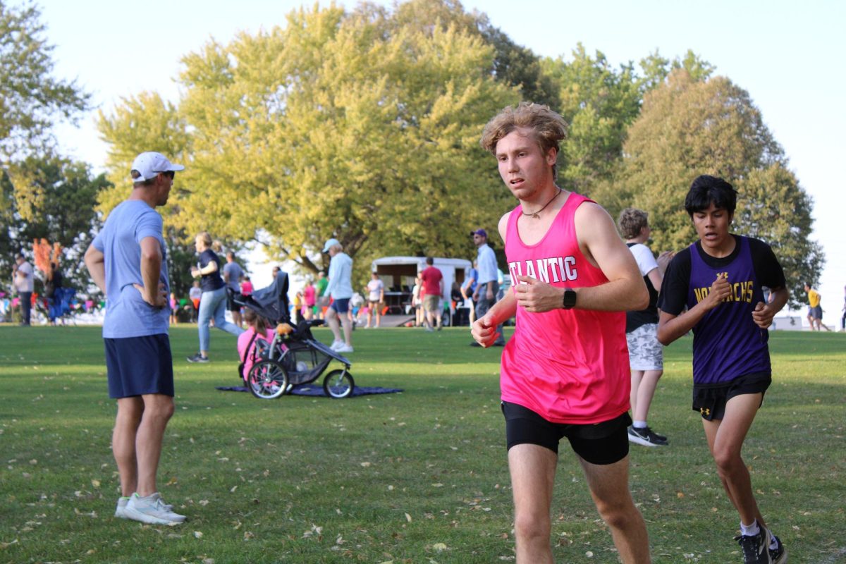 Senior Tye Houser runs during the pink out cross country meet at home. 