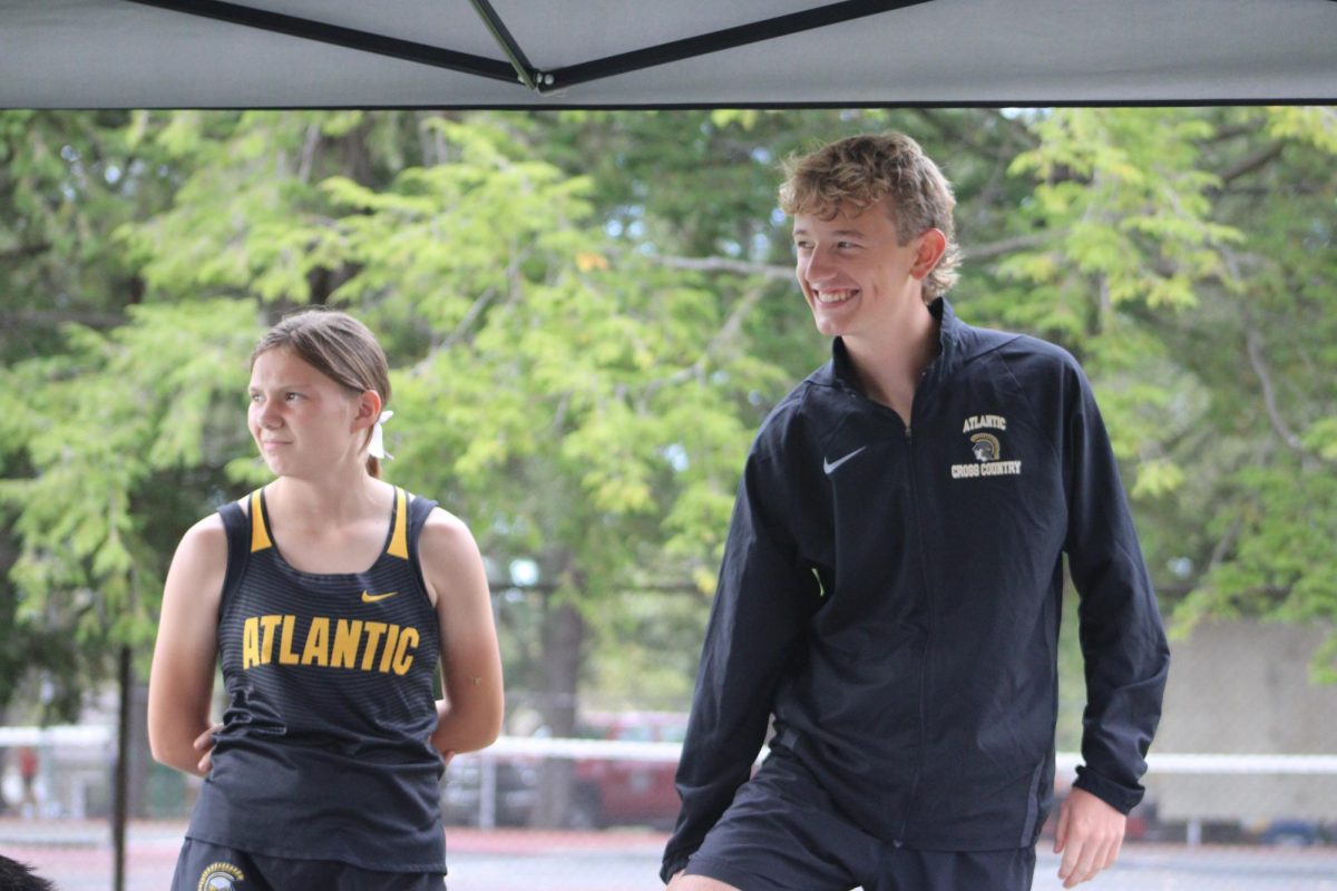 AHS cross country runners Hailey White and Luke Irlmeier wait until its time for their  races while at Newton.