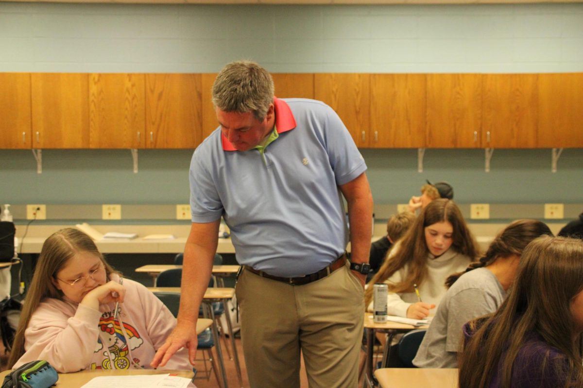 Math teacher Mr. Bartz helps answer sophomore Integra Christensen's question.