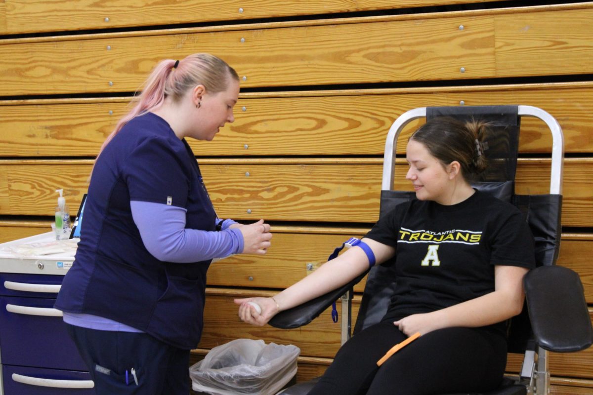 Senior Kylie Templeton gives blood during the blood drive at AHS today.