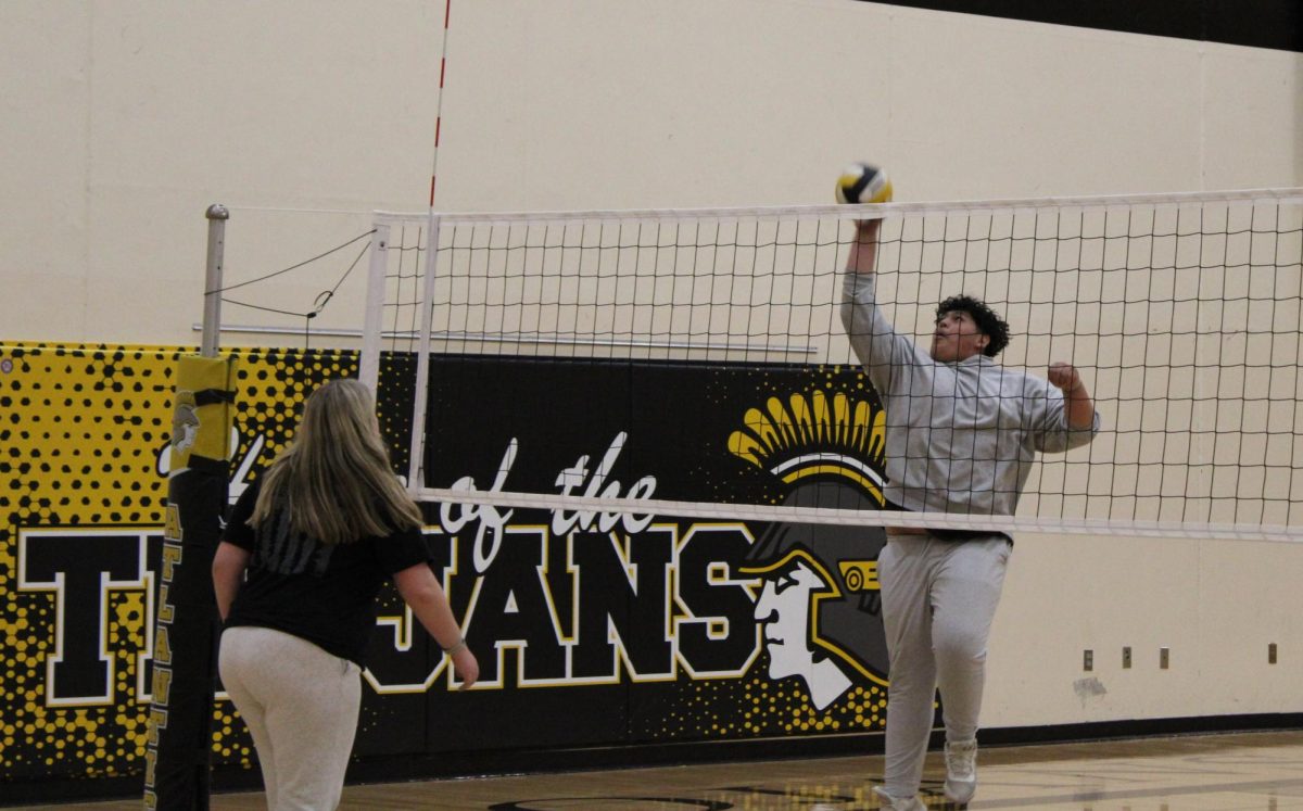 Senior Brian Martinez Perez spikes volleyball at senior Brady Wagner during Mrs. O'Hara's PE class.