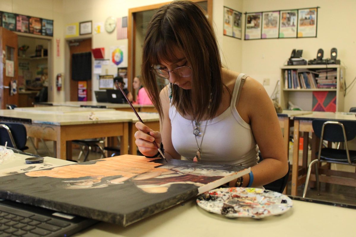 AHS senior Amelia Peterson works on painting her art piece for Ms. Herrick-Williams class!