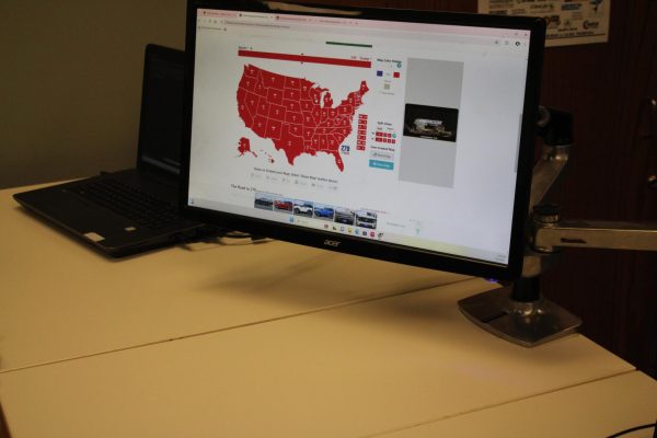 A school computer displays an electoral college vote simulator.