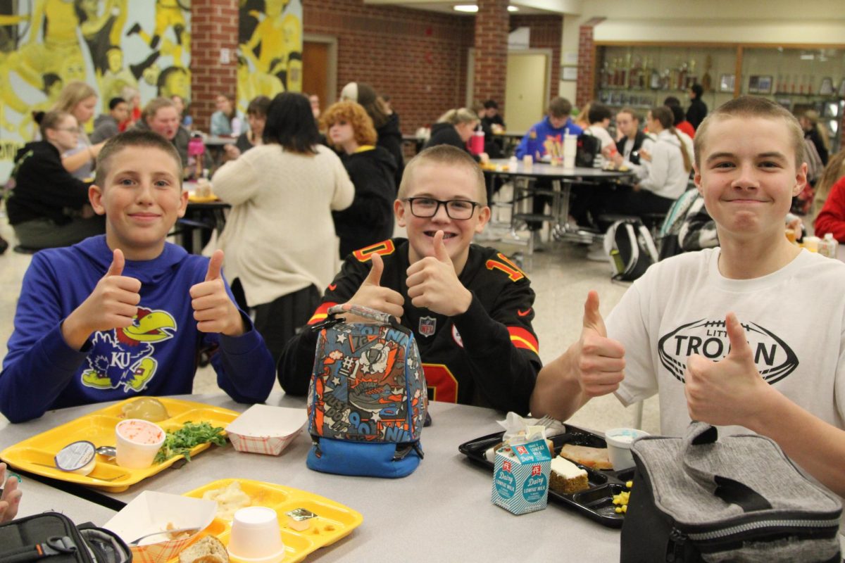 Brandon Wagner, Collin Harris, and Dreven Smith enjoy their lunches as they are asked about their new dos. 