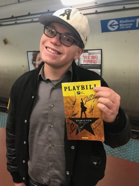Avery Andersen holding one of this favorite play scripts.