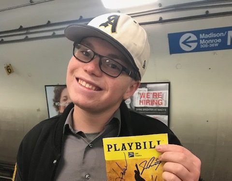 Avery Andersen holding one of this favorite play scripts.