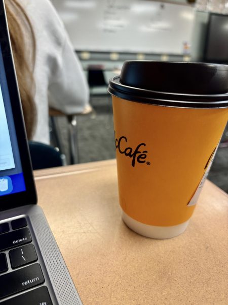 MORNING CUP OF JOE-- An example of how cans and cups line desk walk ways. 