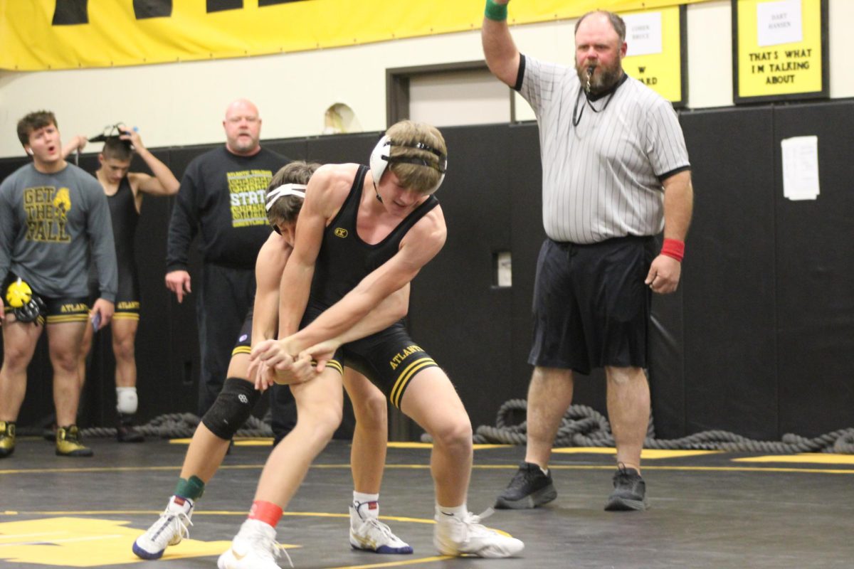 Wrestler Carter Hadley tries to escape from Landon Hagen's hand. Hadley tried to get his hand back to get the point. Hadley successfully earned the point for an escape.  