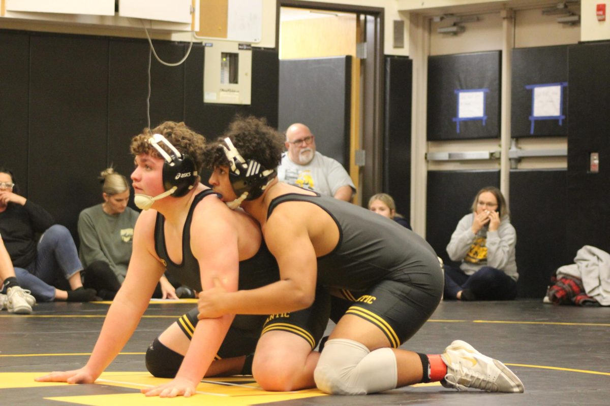 Freshman Travin Thomas and junior Donovan Hedrington wait for a whistle blow. When the whistle is blown, both wrestlers try to earn points. While Thomas tried his best, Hedrington won the match.