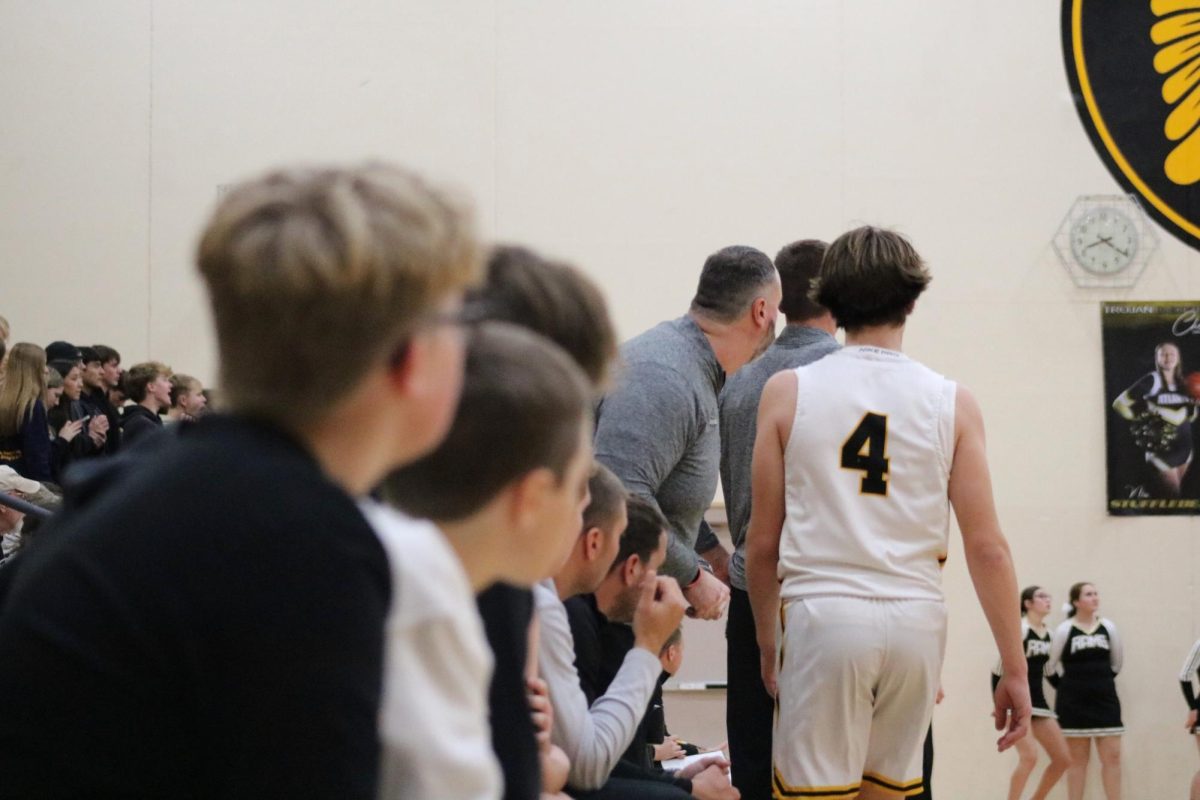 GOOD WORK-- Junior Hudson McLaren collects high-fives from teammates after a hard fought four minutes.