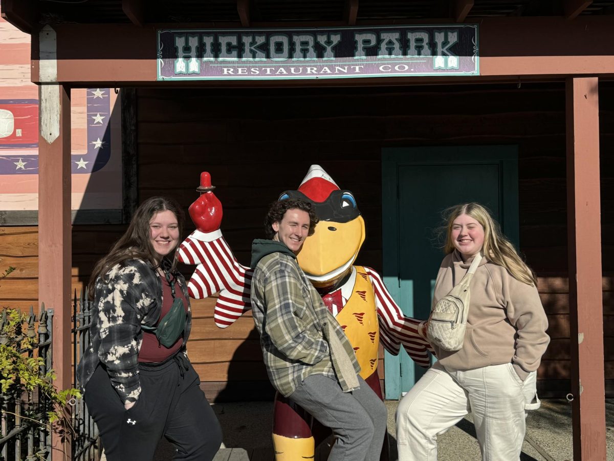 Grace Mitchell, Drayce Moore, and Brady Wagner pose with Cy the Cardinal.