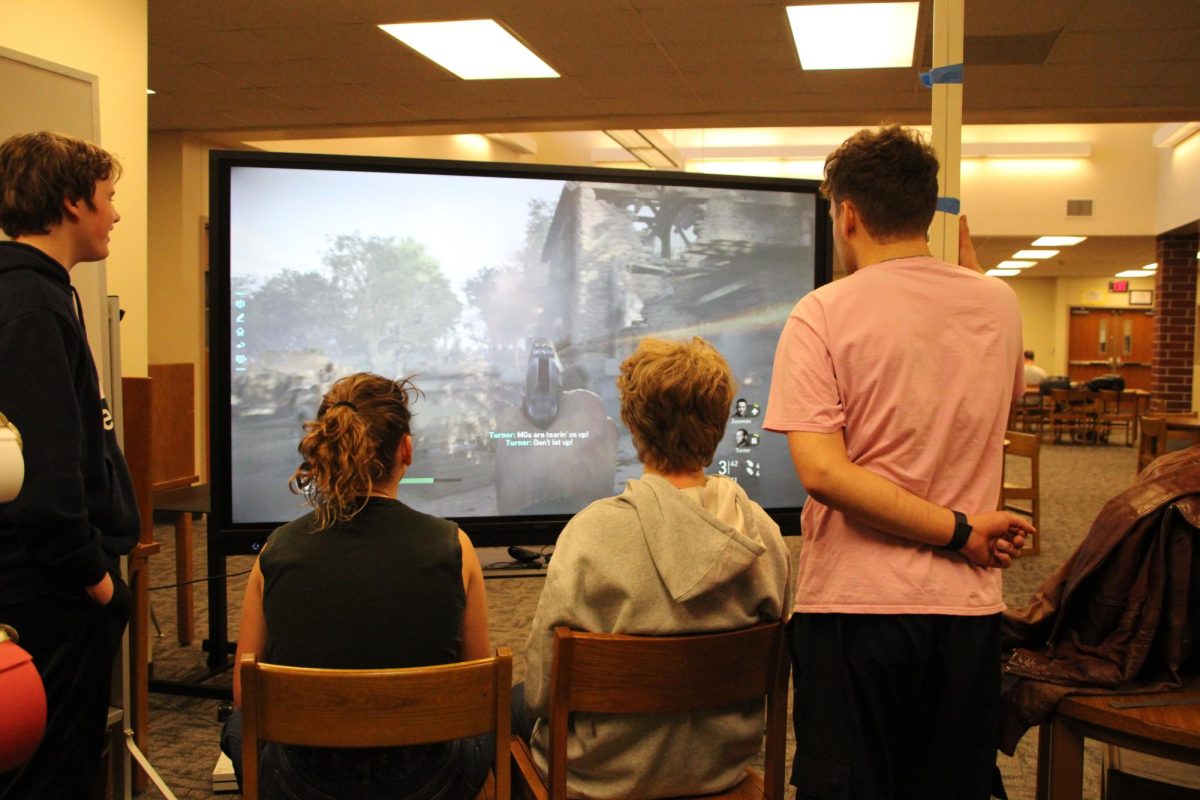 GAMING SESH - Landon Larson, Logan Olson, Wiatt Green, and Noah Huddleson gather to watch the game in progress. The group played Call Of Duty: Cold War, taking turns and commentating to keep the game interesting. Apart from Call of Duty, Super Smash Bros was another favorite of theirs to play during Game Club.