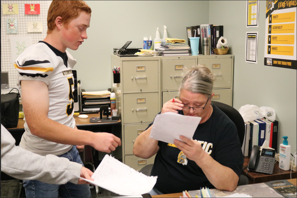 Math teacher Mrs. Hayden checks junior Colin Rudy's work. Students in Hayden's math class turned in their assignments. Rudy had Hayden double check his work.