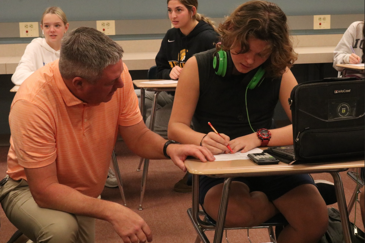 Math teacher Cory Bartz helps freshman Logan Olson-Everett with his math. Olson-Everett worked on a review sheet. He studied hard for his upcoming test.