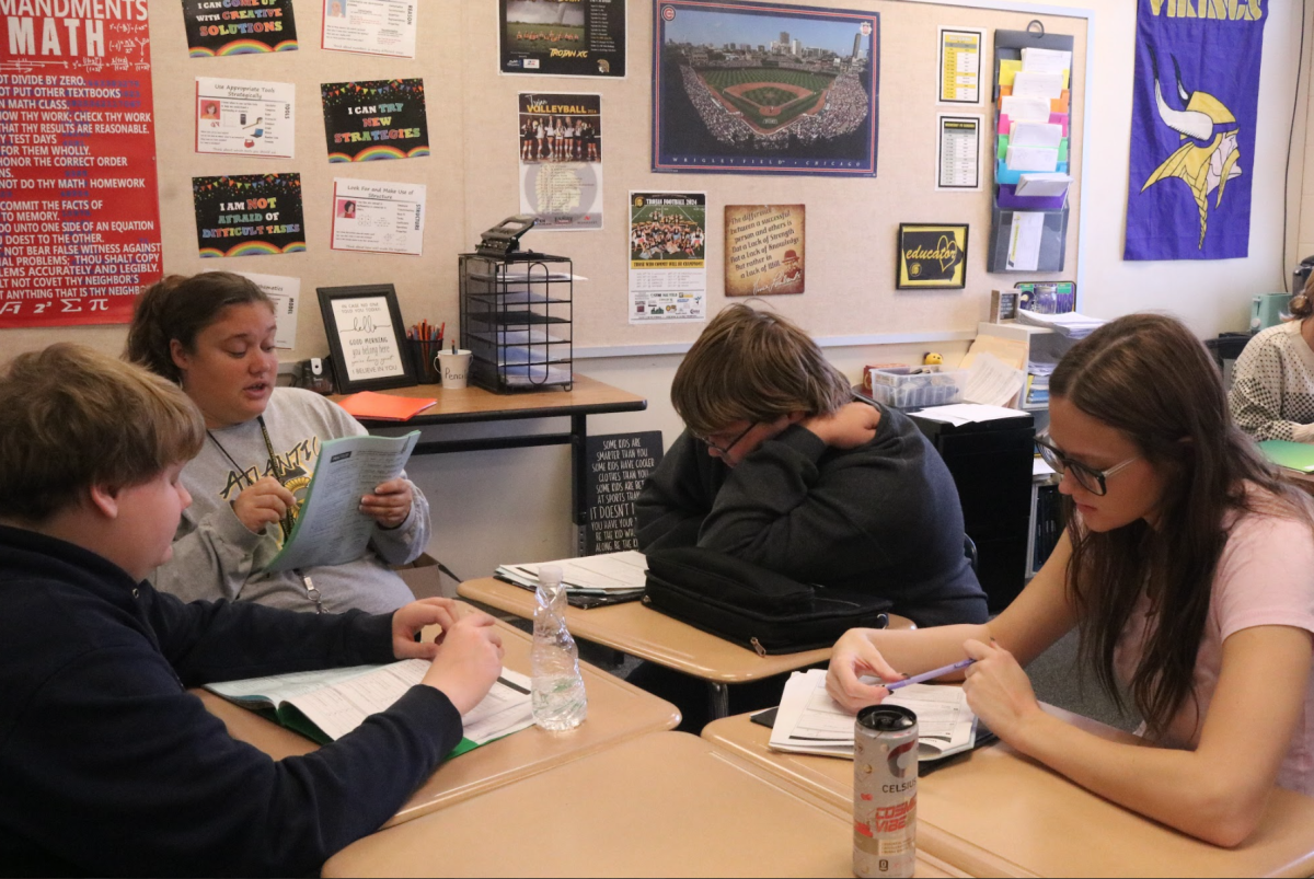 Para Samantha Gunderson helps Phoenix Cameron, Alexander Meyer, and Jaydin Nowatzke with their math packet. Gunderson was going over segment proofs with the students. She provided a lot of help.