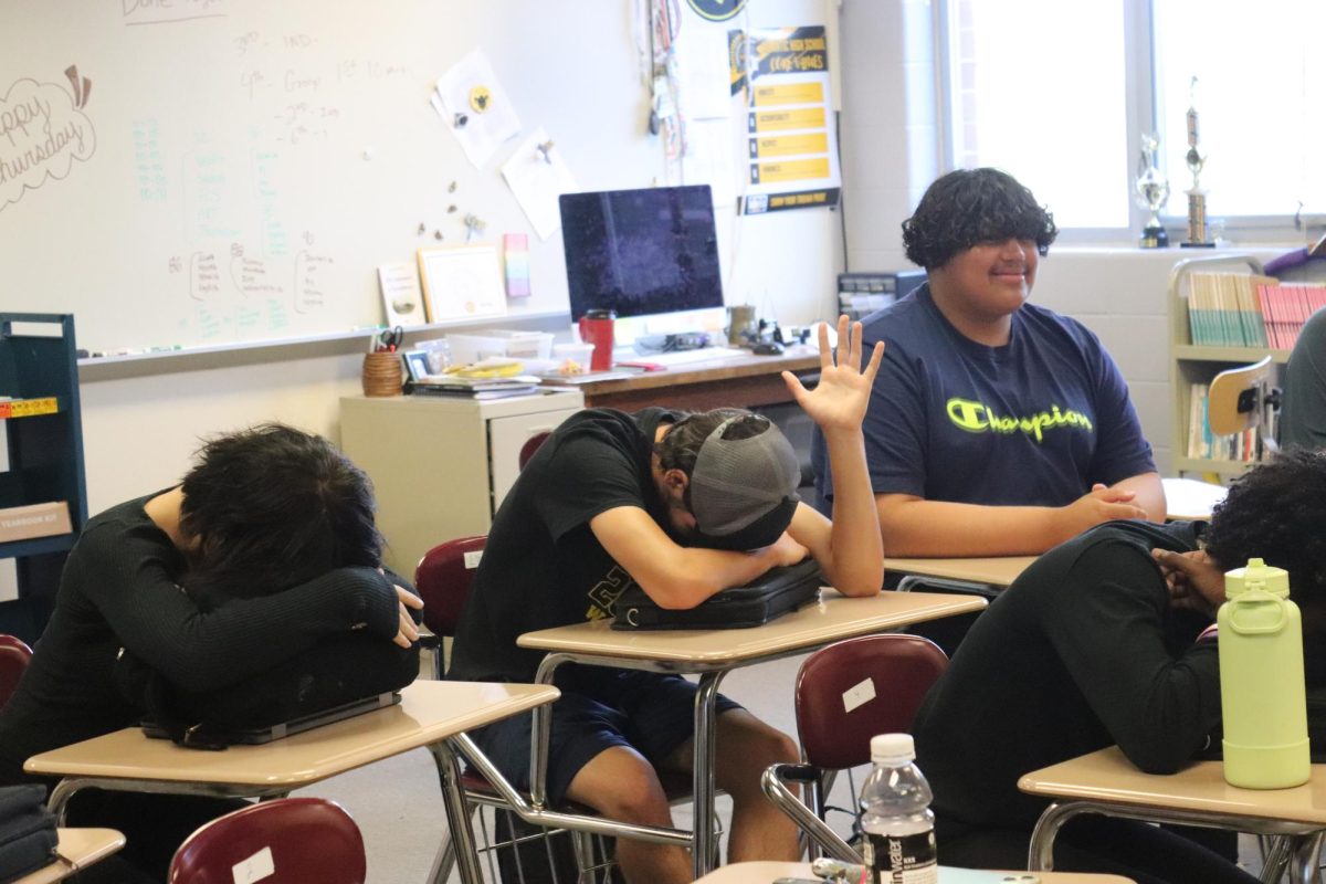 Students rest their heads on desks during class.