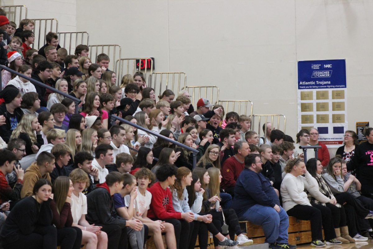 Students gather in the gym during a seminar. Students often rely on their phones, and social media apps such as TikTok for their daily news, information, and updates.