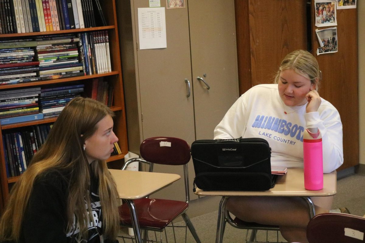 AHS Journalism Social Media team members discuss their next TikTok to post.