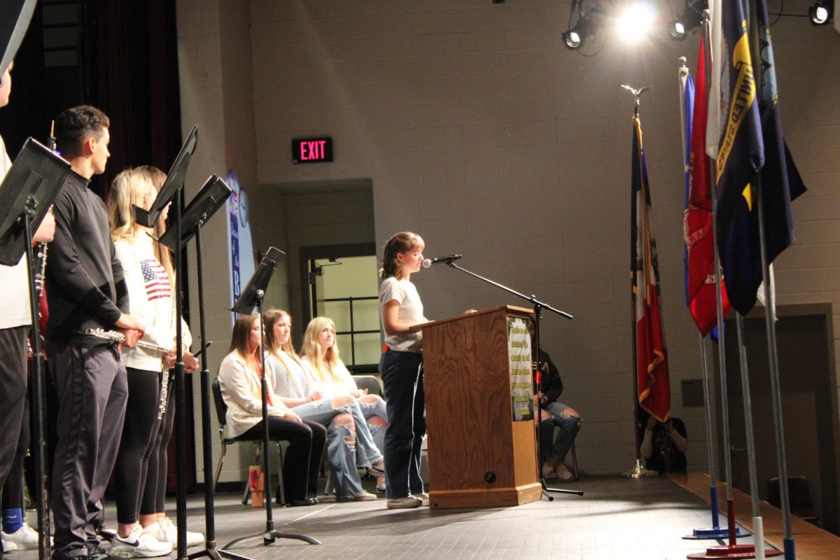 GOD BLESS AMERICA-- Junior Margaret McCurdy addresses the Trojan study body at the Veteran's Day Assembly  this November. 