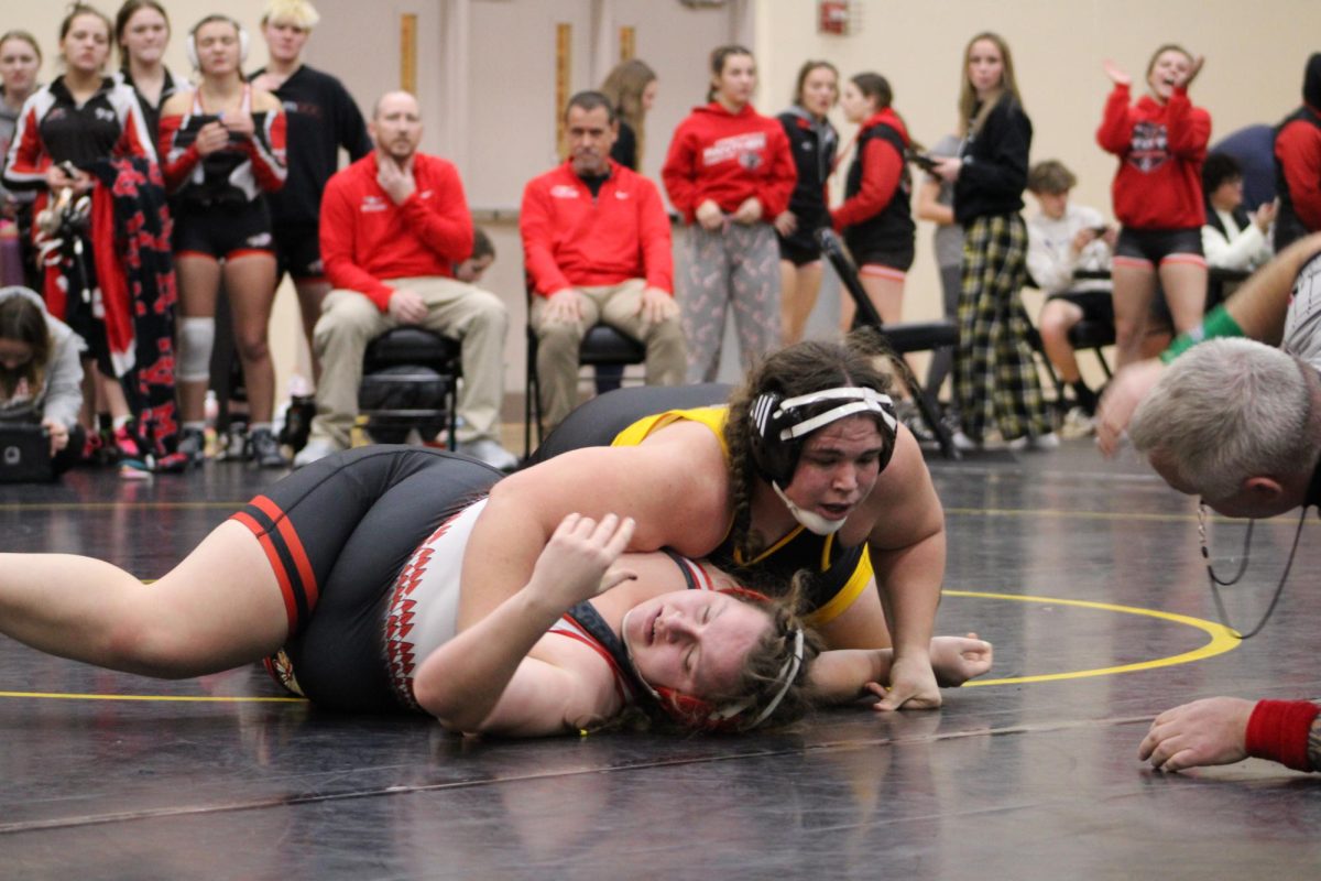 PIN FOR THE WIN!- Junior Haley Armstrong pins her opponent. The ref slapped the mat calling the round. After a short match Armstrong took the win.