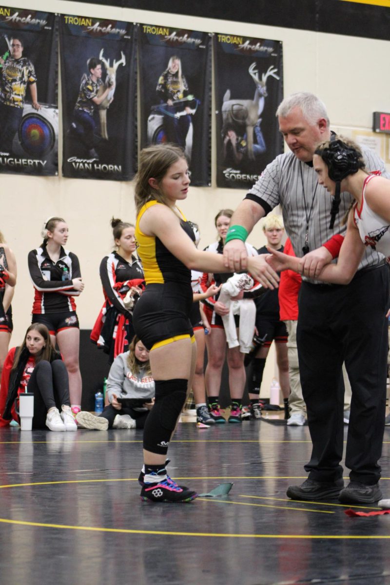 VICTORY!- Sophomore Cadence Kinzie wins her match. After a tough fight Kinzie shakes hands with her opponent. She celebrated with her team after. 