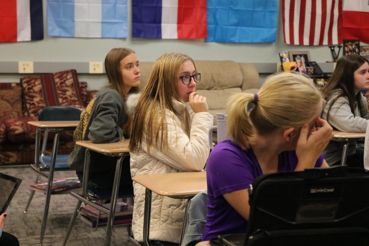 Gabriella Engler, Holly Petersen, and Natalie Smith attend an AHS Fuel Meeting. The Fuel meetings were held before school, and students would appear with morning traits like coffee cups or freshly-showered hair.