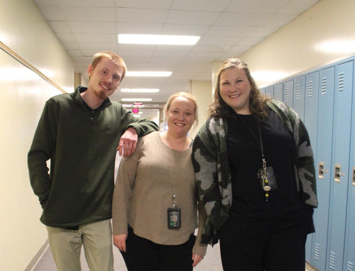 Ben Andersen, Holly Esbeck, and Hannah Misner stop for a photo during their daily walk through the halls on their prep periods. 