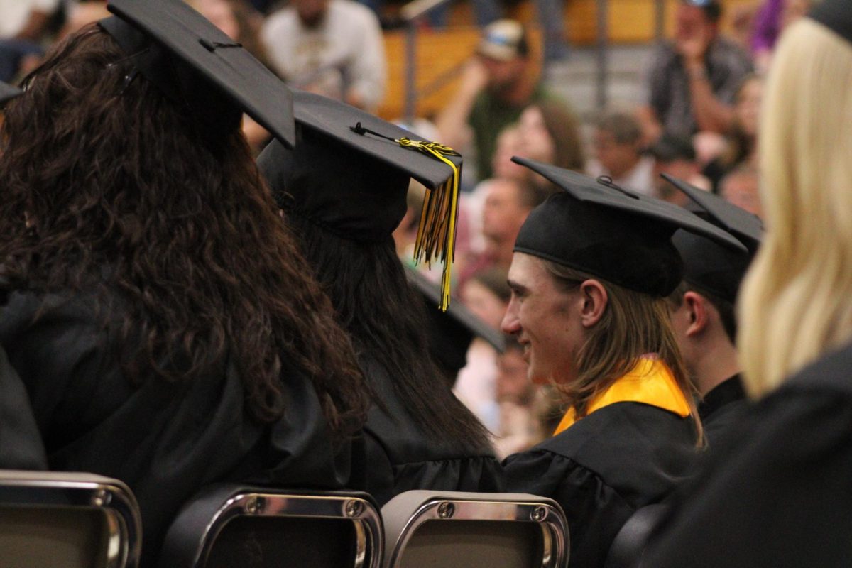 Cameron McDermott smiles while looking straight ahead listening to the speech. McDermott admiring what he heard and enjoying these last high school moments. 