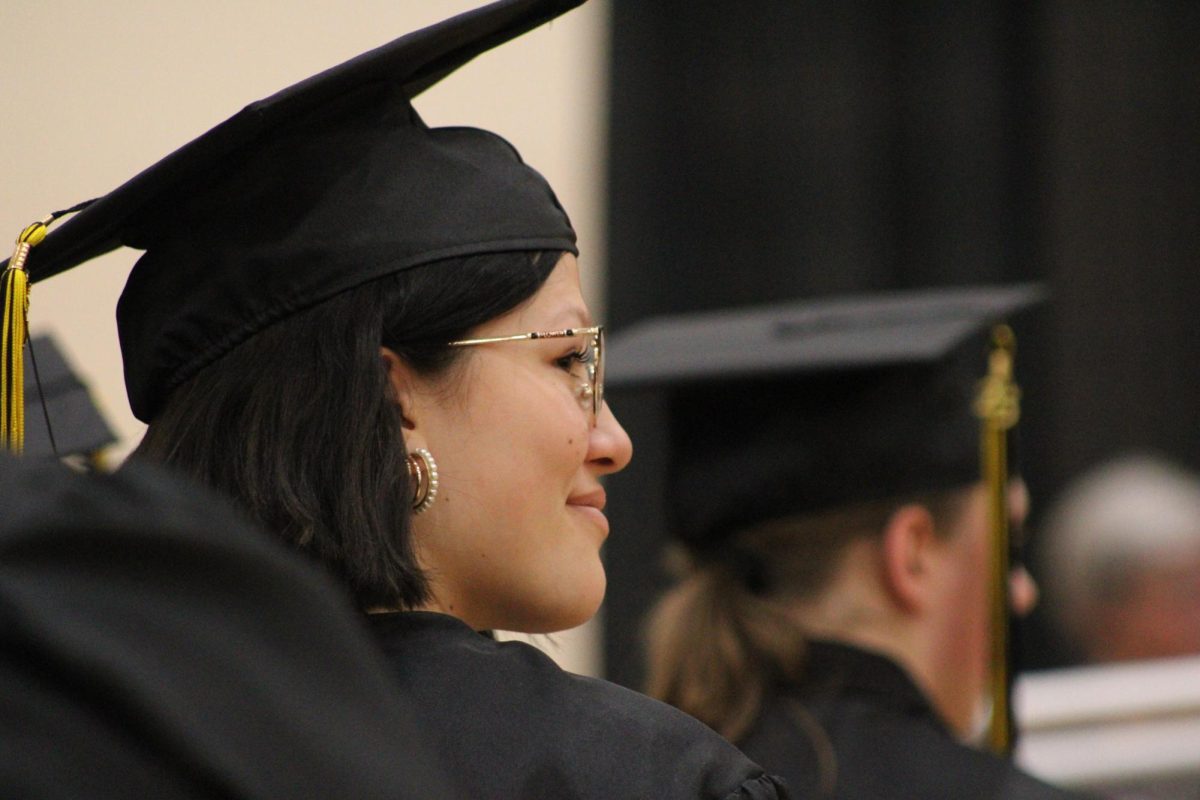Isabella Hamilton smiles while looking at her classmates that are seated on the other side of the aisle. Hamilton could've graduated two years earlier but she decided not to graduate early. 
