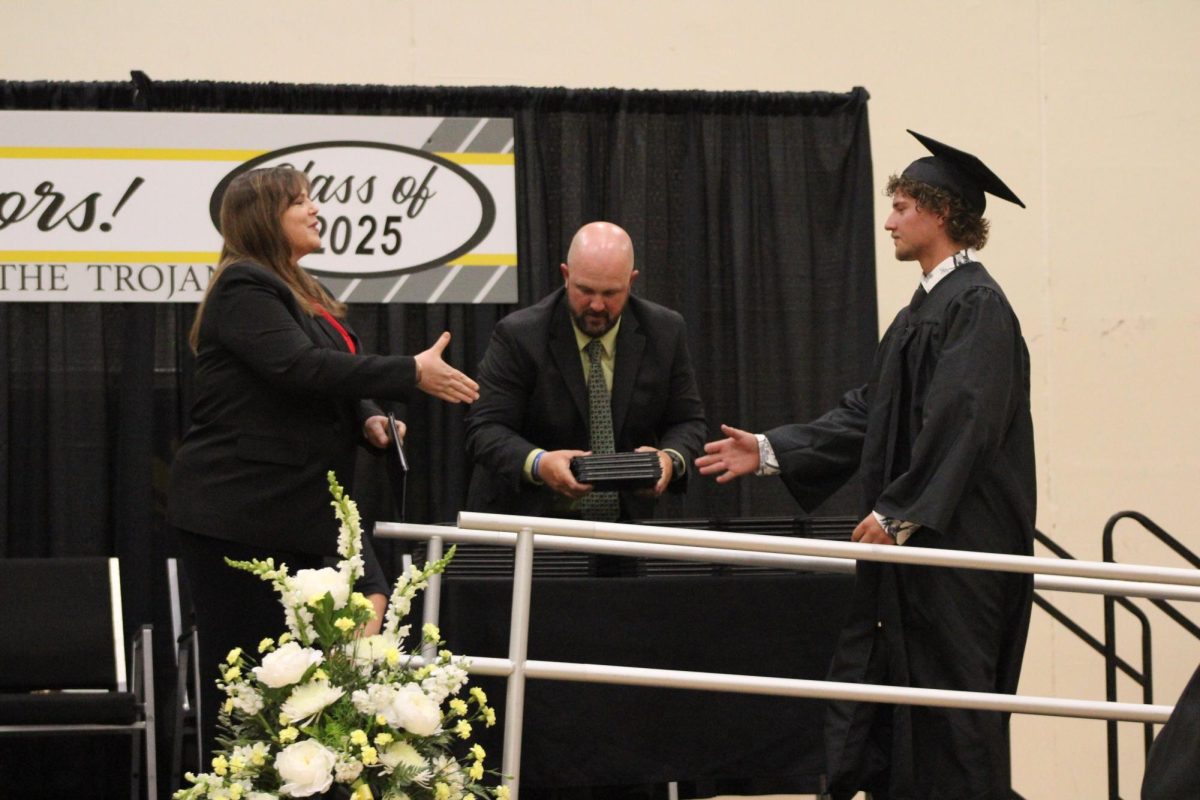Tyson O'Brien walks up the ramp to shake hands and receive his diploma. O'Brien wants to continue his education at Iowa State University and major in biology. 