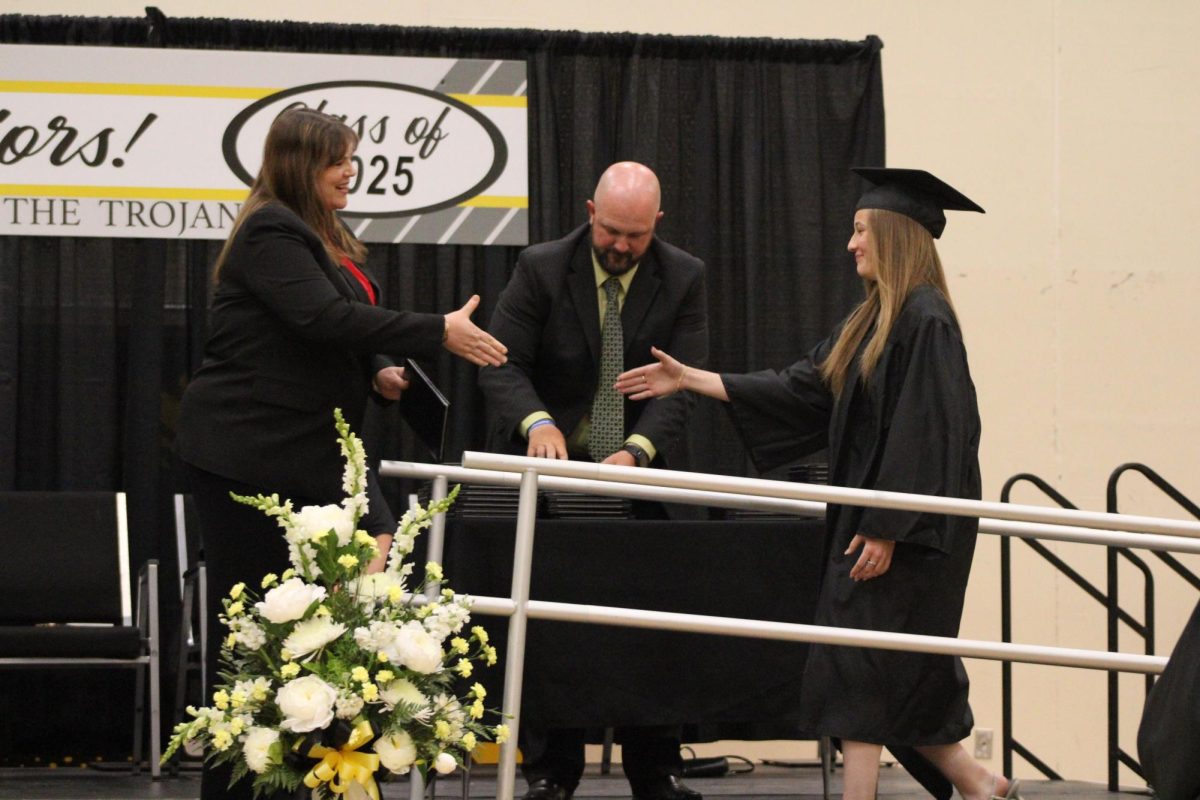 Senior Mabry Ohm is greeted at the top of the ramp by Laura McLean to hand Ohm her diploma. 