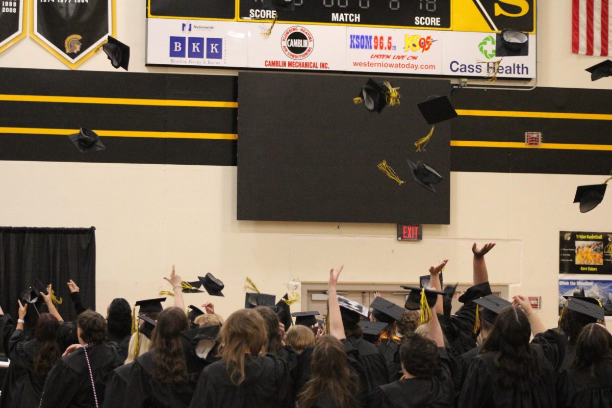 The graduating class of 2025 throw their caps up in the air to celebrate their accomplishment. 