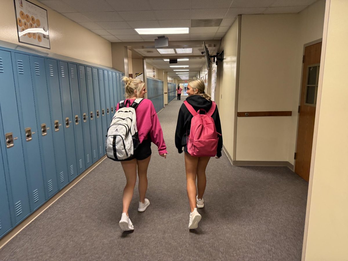 Zoey Kirchhoff and Gracie DeArment are excited to start their senior year and experience all the fun activities. The girls shared a laugh while walking down the hallway. 